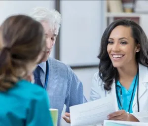 A doctor discussing treatment options with a patient in a hospital room
