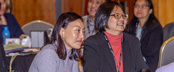 Leadership in Medicine: Southeast Asia program participants in a lecture hall candidly smiling